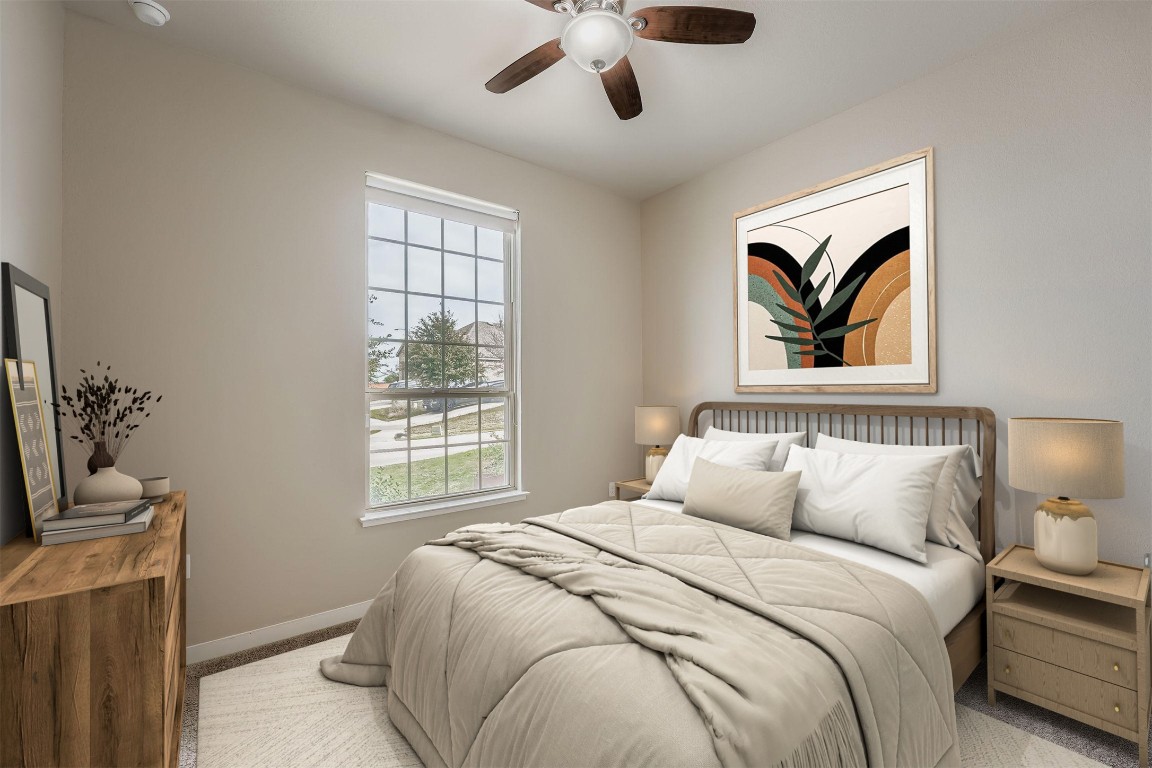 11209 American Mustang Loop Manor, TX 78653 - Photo 22 of 34 a bedroom with a large bed a chandelier and a window