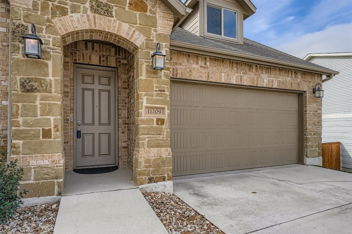 11209 American Mustang Loop Manor, TX 78653 - Photo 3 of 34 a view of entryway with a front door