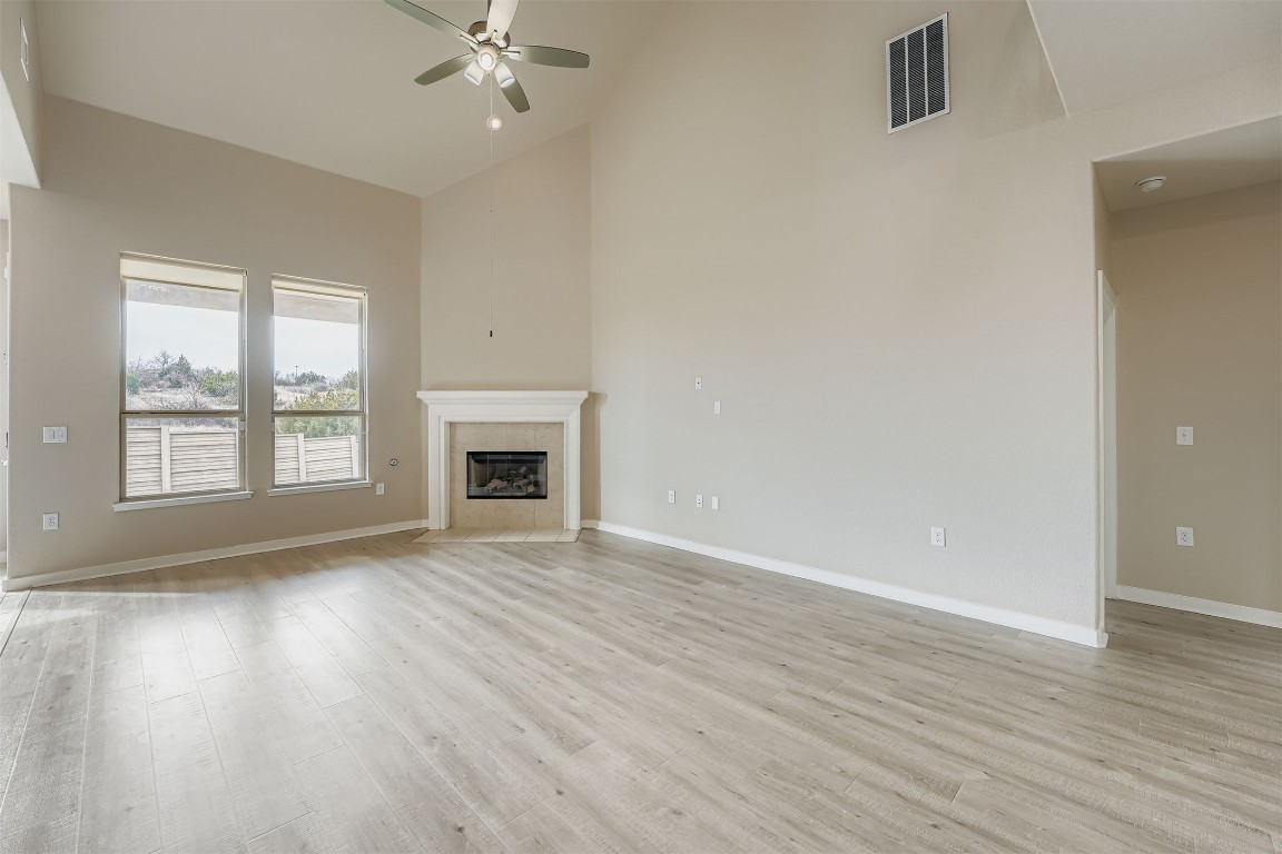 11209 American Mustang Loop Manor, TX 78653 - Photo 4 of 34 wooden floor chandelier and windows in a room