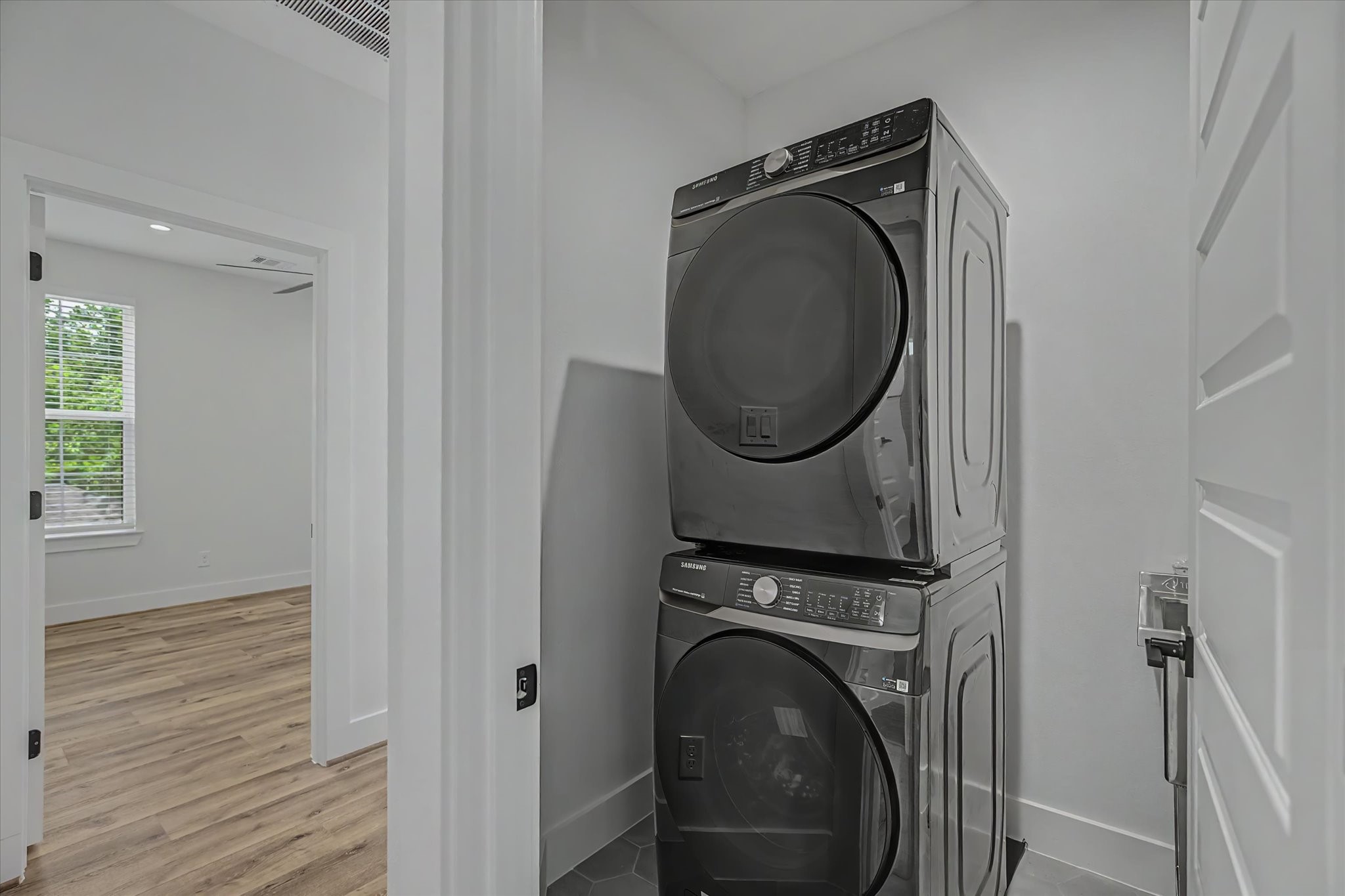 3806 Dreyfus Street Houston, TX 77021 - Photo 31 of 48 Samsung 5.0 cu. ft. Smart Front Load Washer featuring Steam Wash technology and a sleek brushed black finish. This high-efficiency, Wi-Fi-enabled washer uses steam to tackle tough stains while remaining gentle on fabrics, and the Super Speed Wash cycle cleans a full load in just 28 minutes.
Matching Samsung 7.5 cu. ft. Smart Electric Dryer in brushed black. This stackable, Wi-Fi-enabled dryer features Sensor Dry technology, which automatically optimizes drying time and temperature to protect clothing.