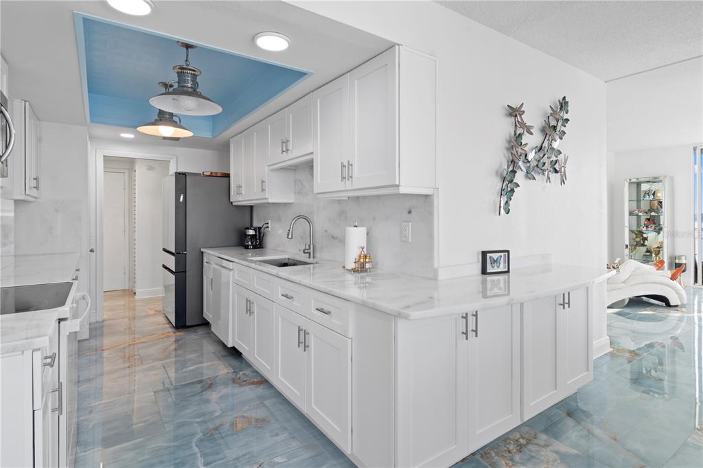 100 Pierce Street, Unit 908 Clearwater, FL 33756 - Photo 12 of 32 a kitchen with granite countertop a sink stainless steel appliances and cabinets