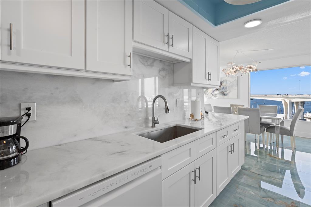 100 Pierce Street, Unit 908 Clearwater, FL 33756 - Photo 15 of 32 a kitchen with stainless steel appliances granite countertop a sink and cabinets