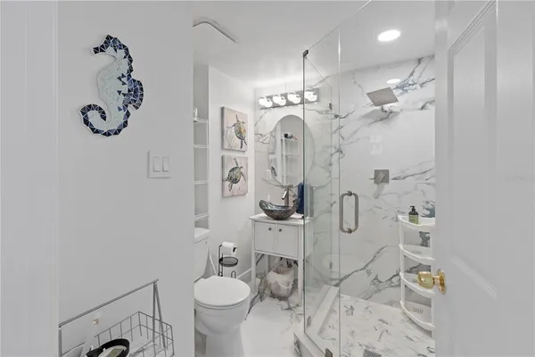 a bathroom with a sink toilet and shower