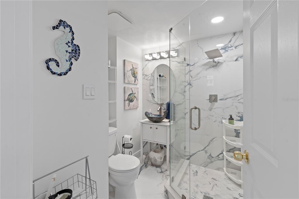 100 Pierce Street, Unit 908 Clearwater, FL 33756 - Photo 17 of 32 a bathroom with a sink toilet and shower