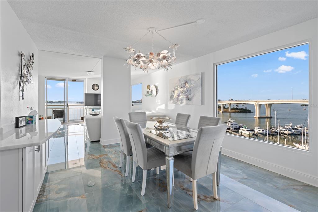 100 Pierce Street, Unit 908 Clearwater, FL 33756 - Photo 18 of 32 a dining room with furniture a kitchen and chandelier