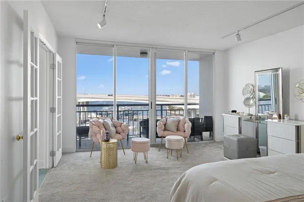 a living room with furniture and floor to ceiling window