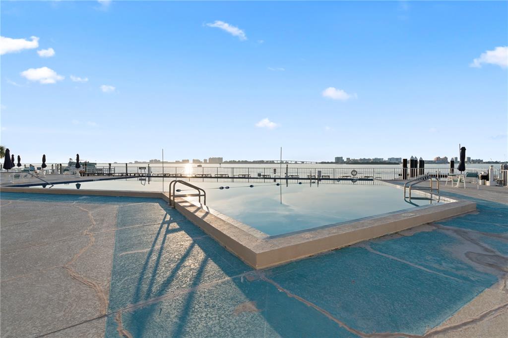 100 Pierce Street, Unit 908 Clearwater, FL 33756 - Photo 2 of 32 a view of a swimming pool and an outdoor seating