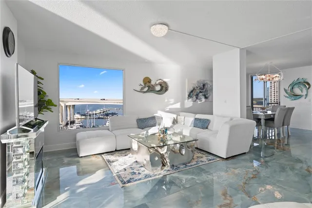 a living room with furniture a rug and a flat screen tv