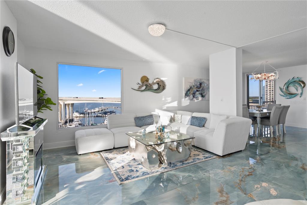 100 Pierce Street, Unit 908 Clearwater, FL 33756 - Photo 21 of 32 a living room with furniture a rug and a flat screen tv