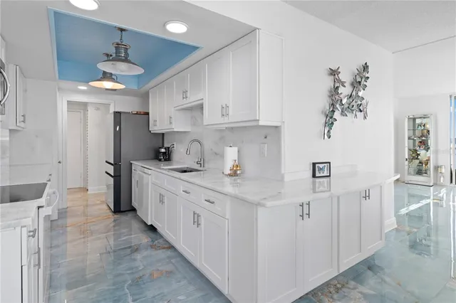 a kitchen with granite countertop a sink stainless steel appliances and cabinets