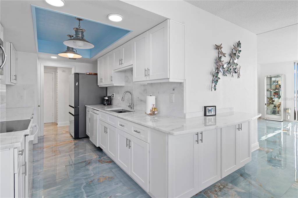 100 Pierce Street, Unit 908 Clearwater, FL 33756 - Photo 22 of 32 a kitchen with granite countertop a sink stainless steel appliances and cabinets