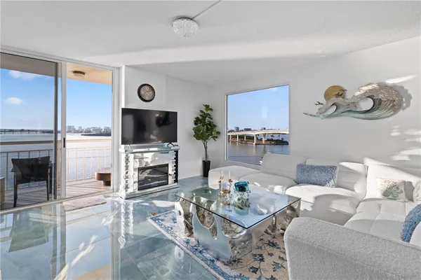a living room with furniture flat screen tv and a fireplace