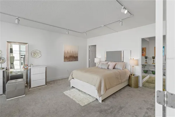 a spacious bedroom with a bed and furniture