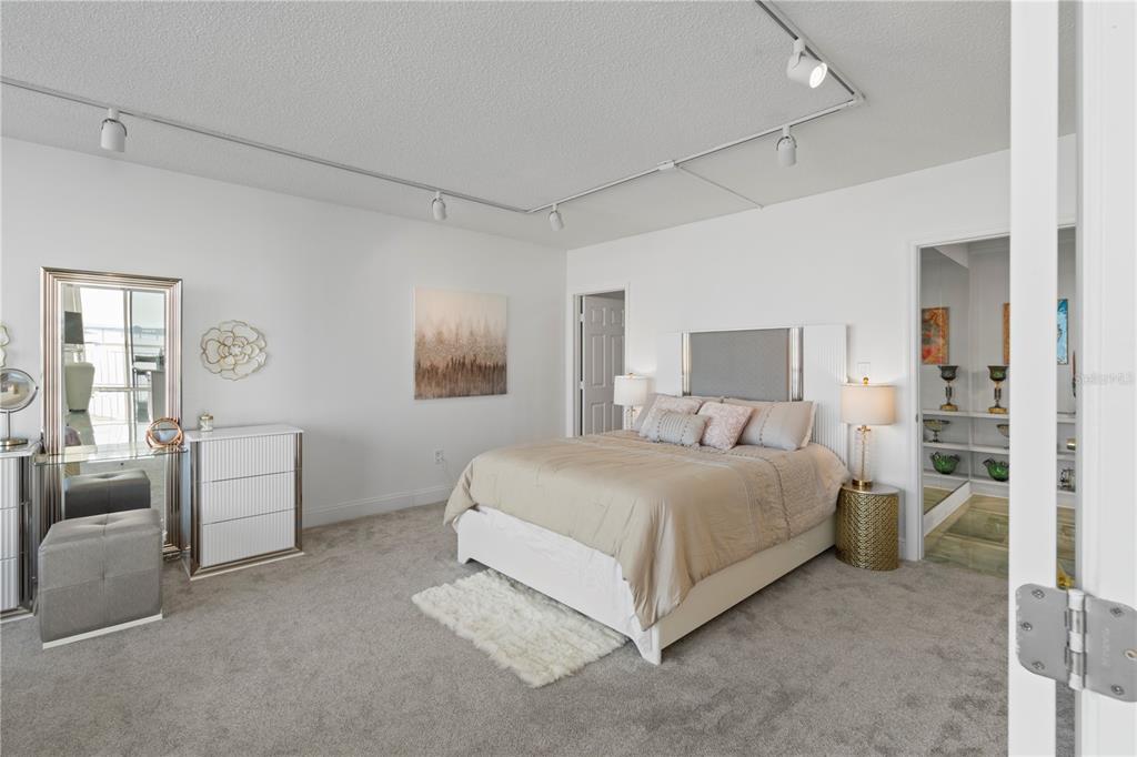100 Pierce Street, Unit 908 Clearwater, FL 33756 - Photo 4 of 32 a spacious bedroom with a bed and furniture