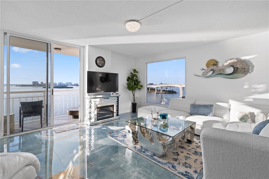 100 Pierce Street, Unit 908 Clearwater, FL 33756 - Photo 5 of 32 a living room with furniture flat screen tv and a fireplace