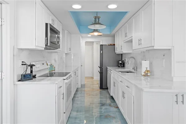 a kitchen with stainless steel appliances kitchen island granite countertop a sink stove and cabinets