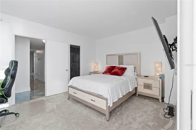 a bed room with a bed and a chair