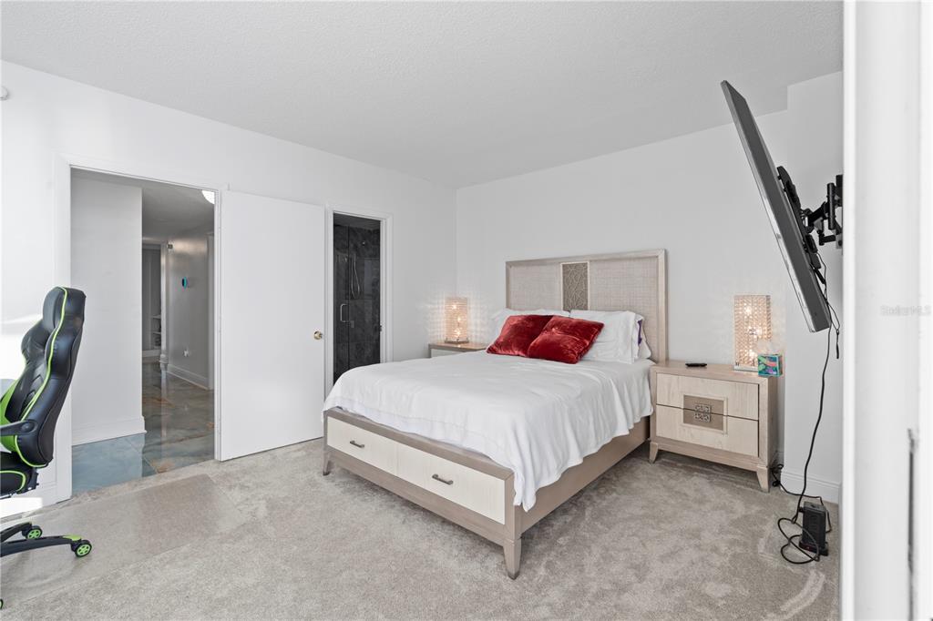 100 Pierce Street, Unit 908 Clearwater, FL 33756 - Photo 7 of 32 a bed room with a bed and a chair