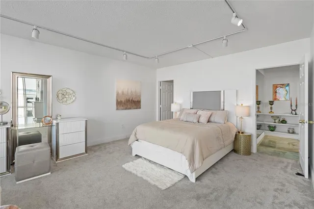 a spacious bedroom with a bed and furniture