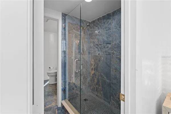 a bathroom with a glass shower door