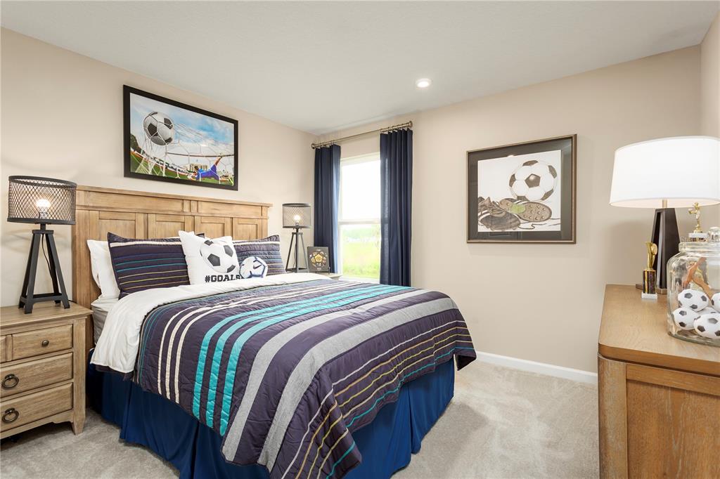 2294 Scenic Pk Loop Wimauma, FL 33598 - Photo 12 of 15 a bedroom with bed and painting on the wall