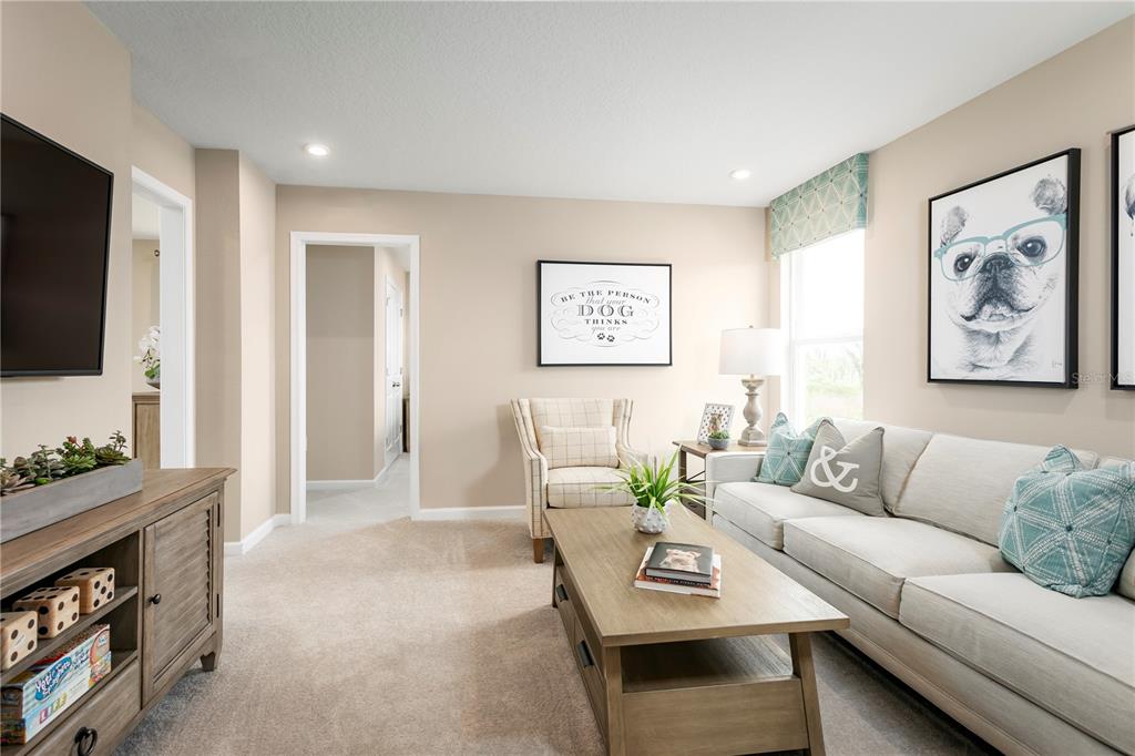 2294 Scenic Pk Loop Wimauma, FL 33598 - Photo 2 of 15 a living room with furniture and a flat screen tv