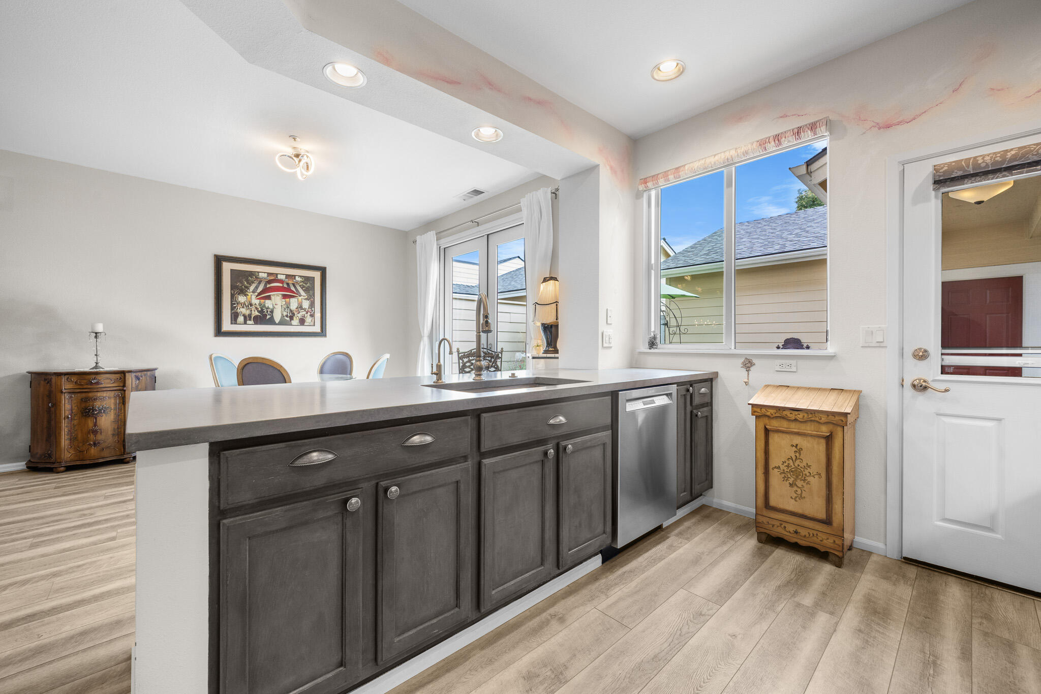 624 Southwest Hill Street Bend, OR 97702 - Photo 11 of 45 a kitchen with granite countertop a sink cabinets stainless steel appliances and a window