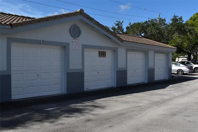 a view of a room with a ceiling fan and window