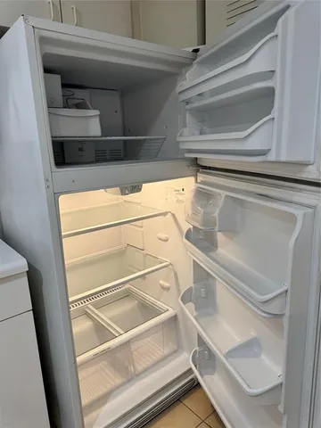 a stove top oven sitting inside of a kitchen