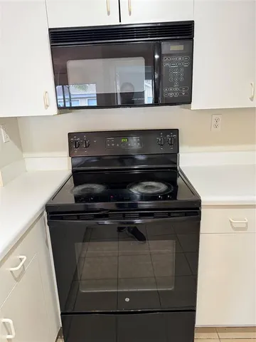 a view of a patio with table and chairs