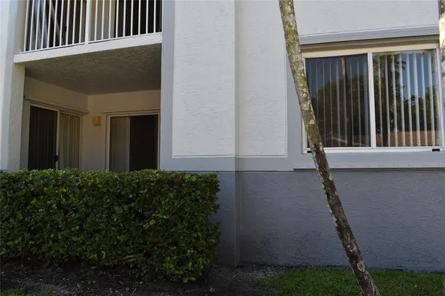 a view of a hallway with wooden floor and closet