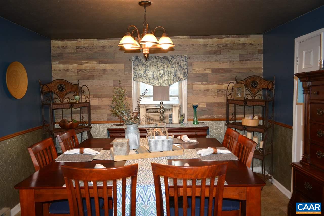 2720 Cedar Lane Road Kents Store, VA 23084 - Photo 11 of 27 a dining room with furniture a chandelier a rug and a window