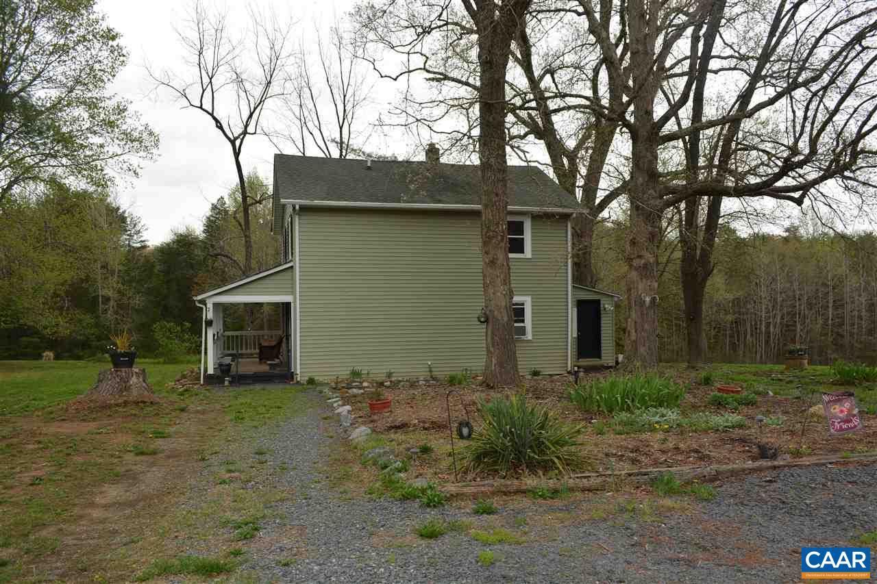 2720 Cedar Lane Road Kents Store, VA 23084 - Photo 3 of 27 a backyard of a house with plants and large trees
