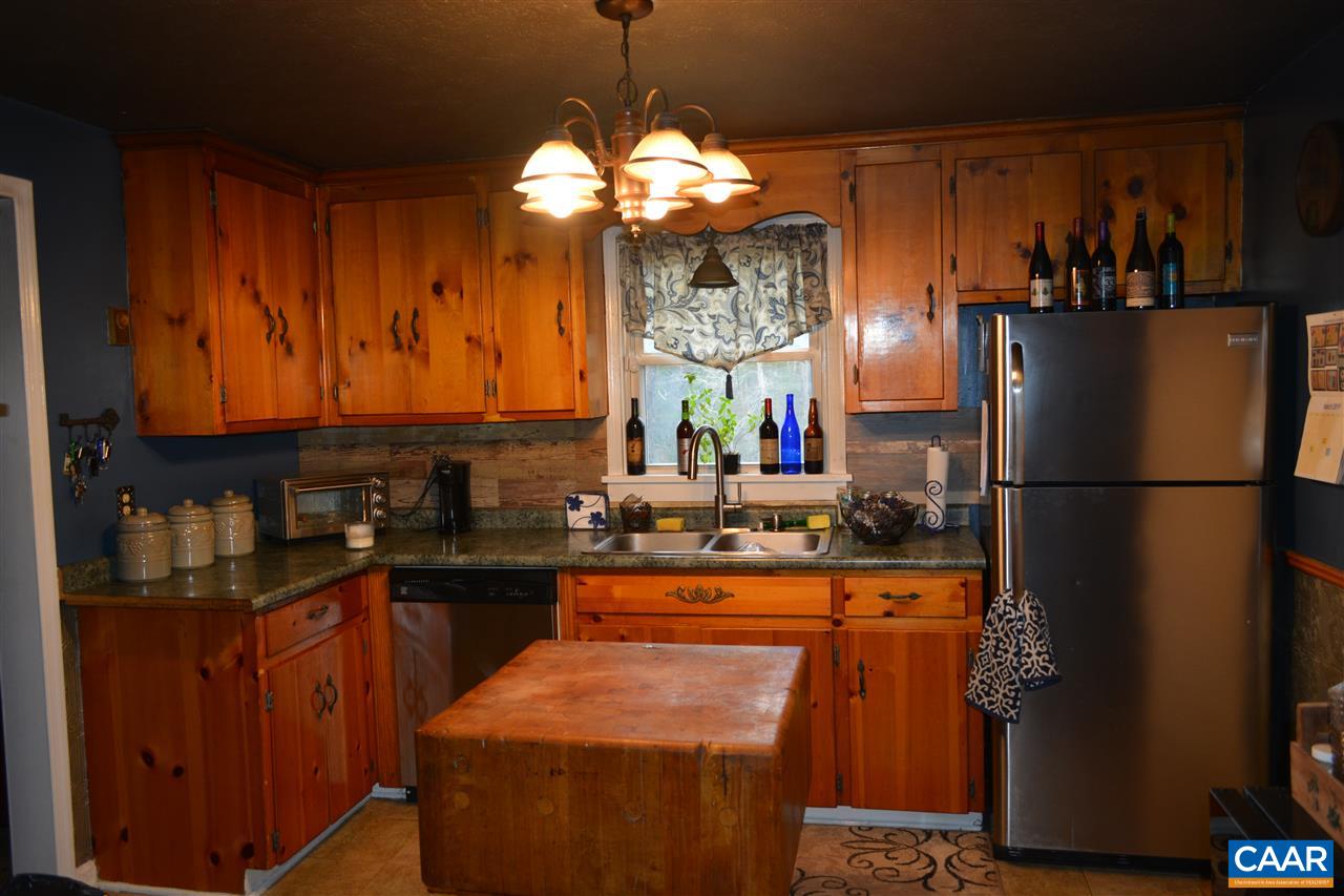 2720 Cedar Lane Road Kents Store, VA 23084 - Photo 9 of 27 a kitchen with refrigerator and cabinets