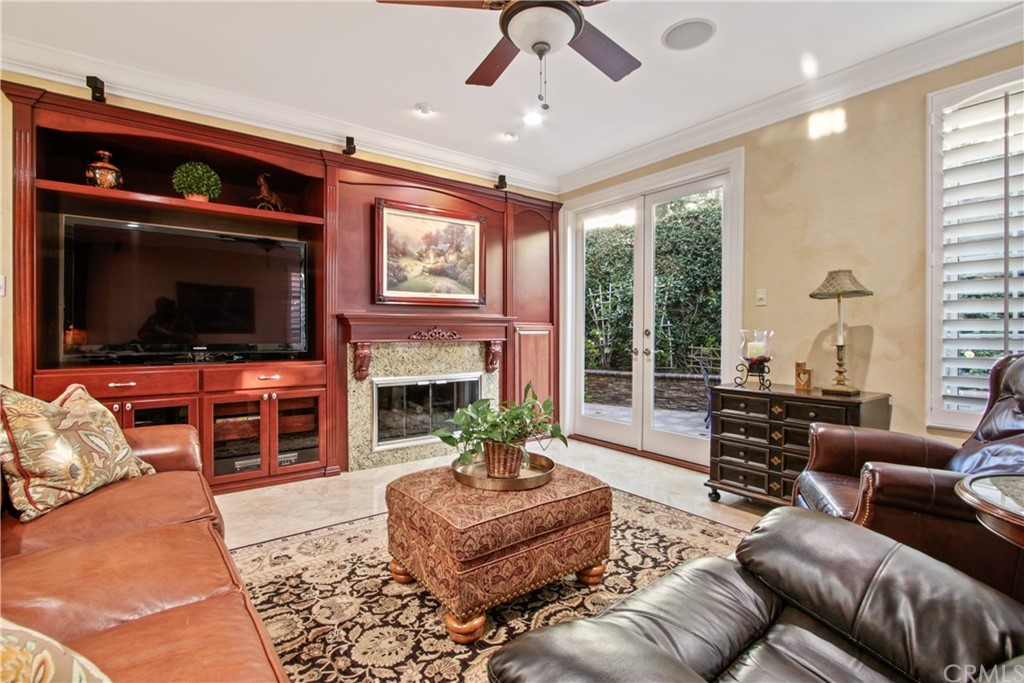 11610 Goetting Avenue Tustin, CA 92782 - Photo 16 of 62 a living room with furniture a flat screen tv and a fireplace