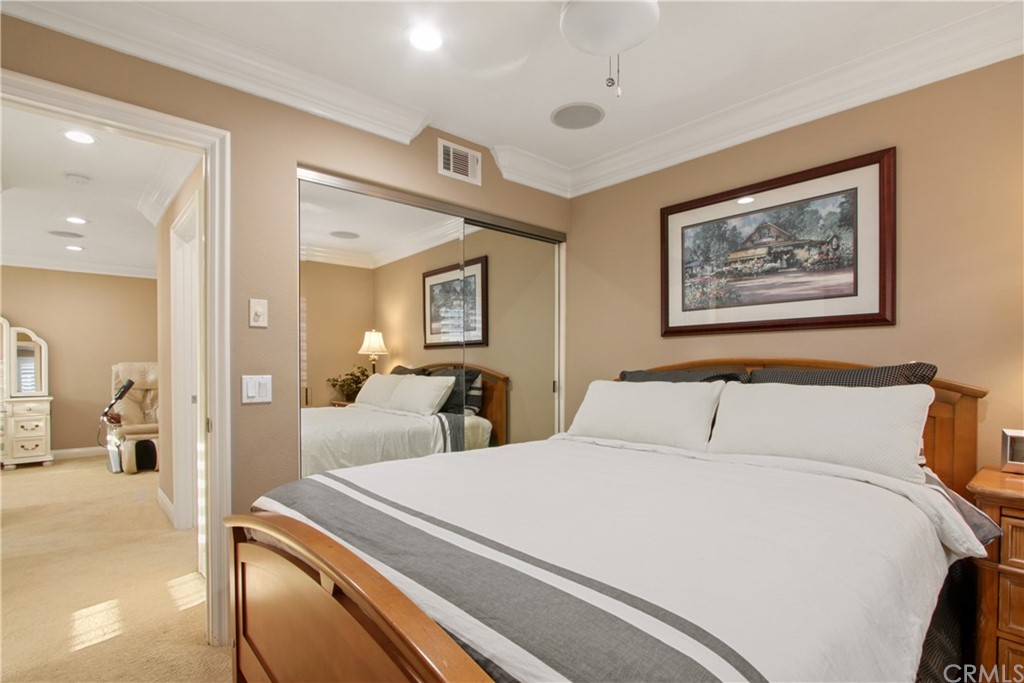 11610 Goetting Avenue Tustin, CA 92782 - Photo 32 of 62 a bedroom with a bed and a large mirror