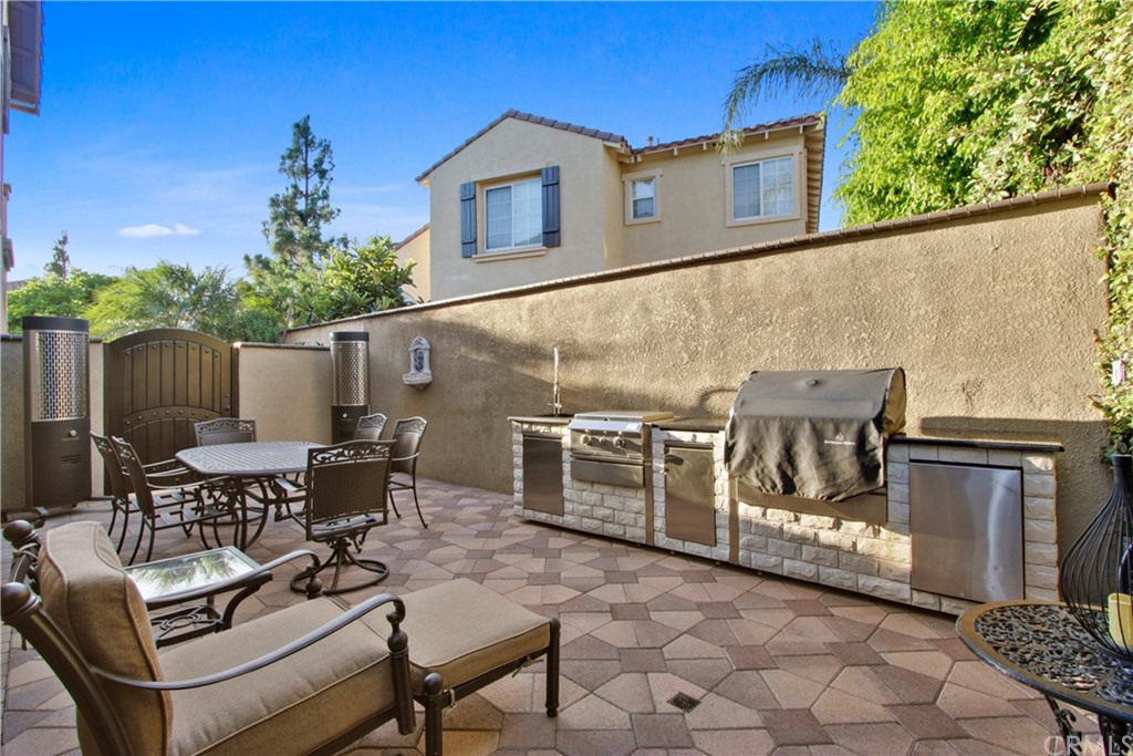 11610 Goetting Avenue Tustin, CA 92782 - Photo 45 of 62 a view of a patio with couches table and chairs and potted plants