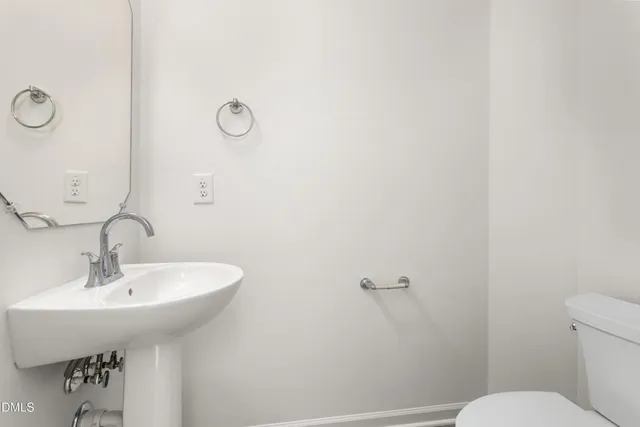 a bathroom with a sink a toilet and mirror