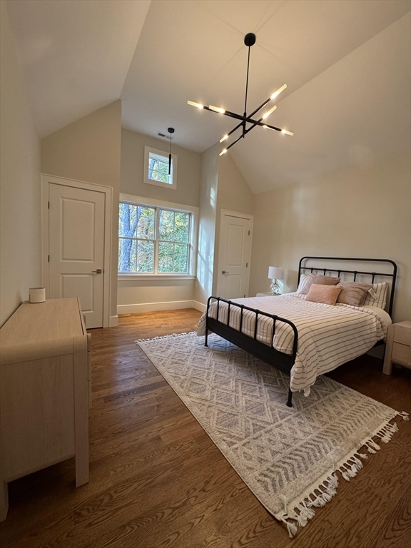 91 Seaver Street Wellesley, MA 02481 - Photo 12 of 18 a bedroom with a bed chandelier and a window