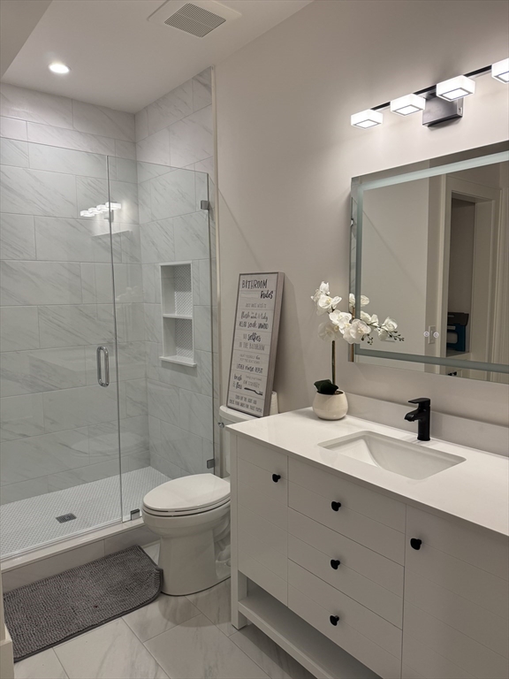 91 Seaver Street Wellesley, MA 02481 - Photo 14 of 18 a bathroom with a sink a toilet and shower