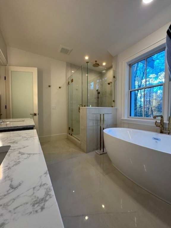 91 Seaver Street Wellesley, MA 02481 - Photo 10 of 18 a bathroom with a tub a sink and a large mirror