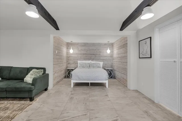 a bedroom with a bed and a flat screen tv