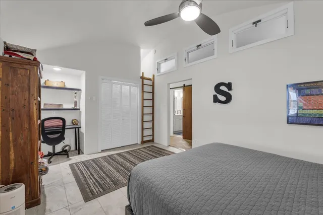 a bedroom with bed and a book shelf