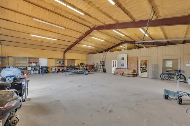 a kitchen with stainless steel appliances kitchen island granite countertop a sink stove and refrigerator