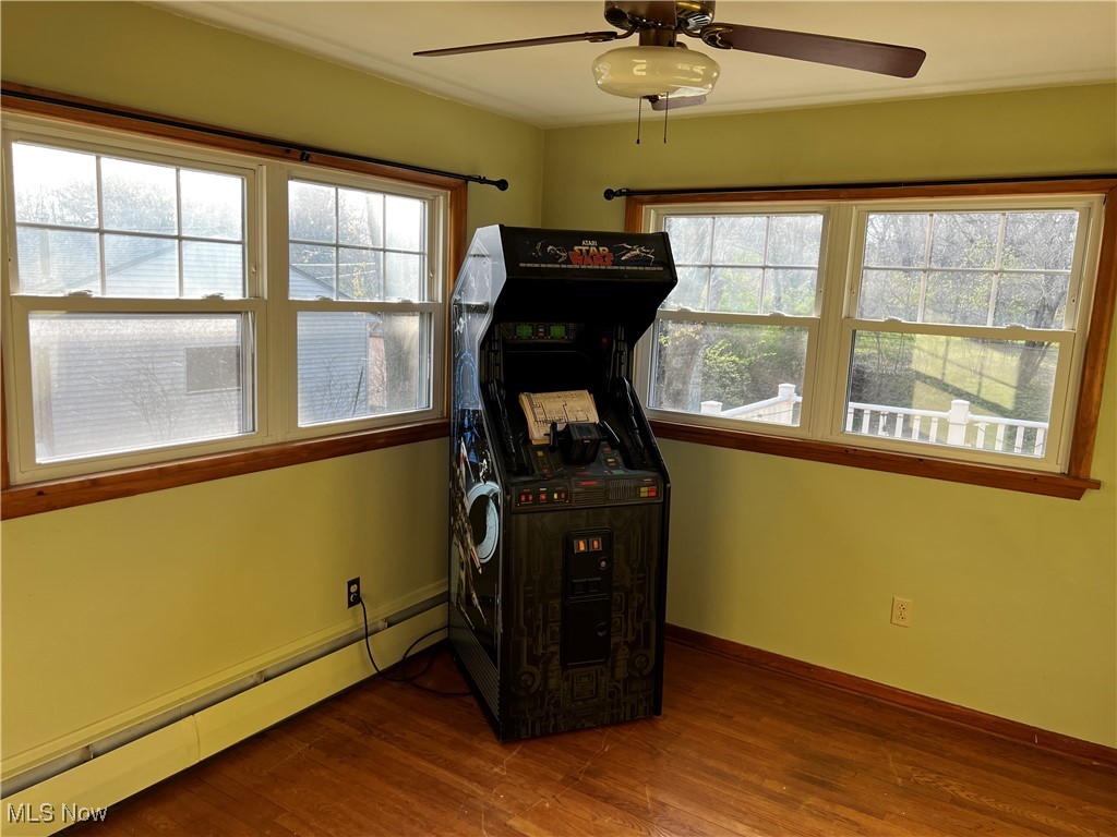 912 Middlebury Road Kent, OH 44240 - Photo 1 of 5 Workout room featuring a baseboard radiator, ceiling fan, plenty of natural light, and dark wood-style flooring