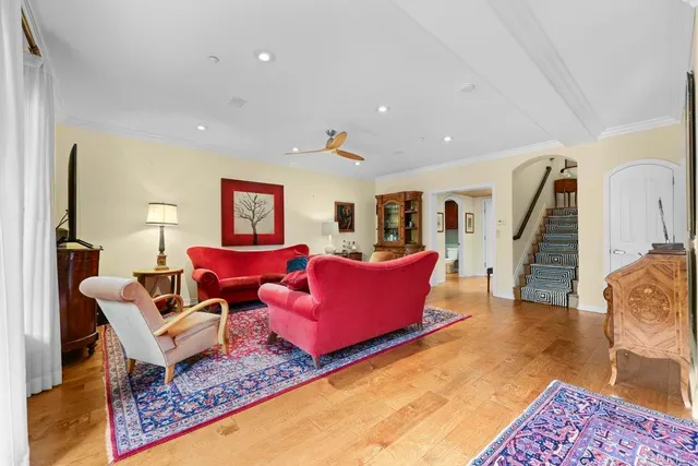 a living room with furniture rug and wooden floor
