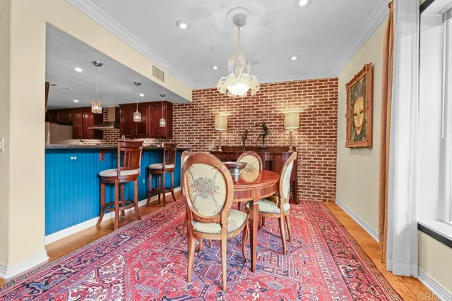 a dining room with furniture a rug and wooden floor