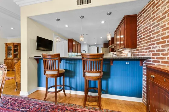 a living room with table chairs and a flat screen tv