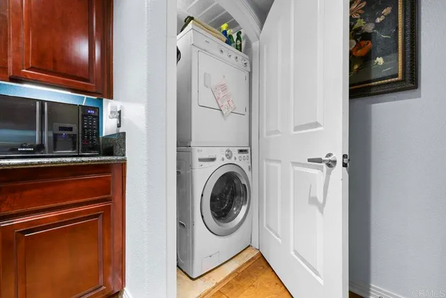 a view of a hallway with wooden floor and windows