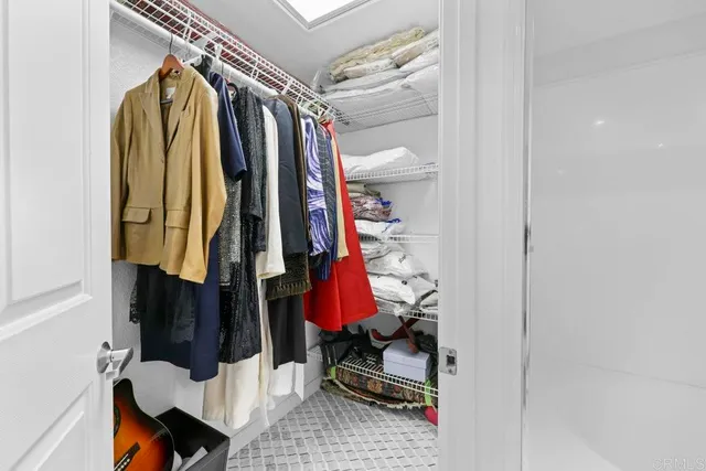 a spacious bathroom with a granite countertop sink and a mirror